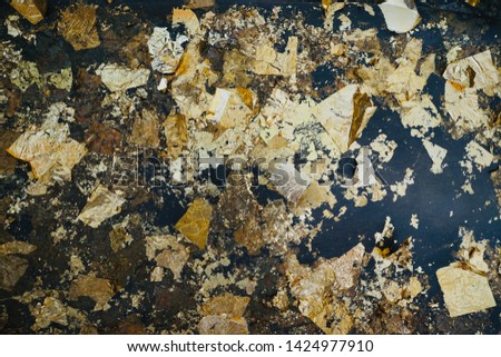 gold leaf gilding no pattern on black background from Statue of Buddha