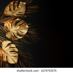 Gold Leaf Isolated On A Black Background  Top View. Gold Palm, Monstera Leaves , Plant Frame With Copy Space. Abstract Poster.