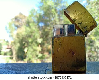 The Gold Lighter And Nature Background