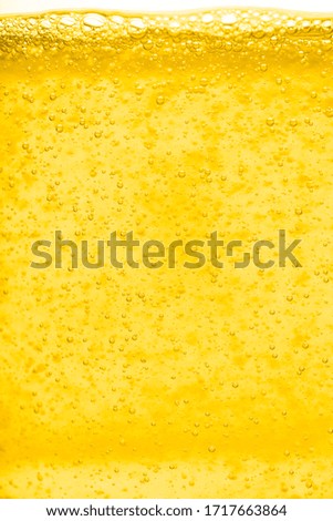Gold  liquid bubble background with bubbles. Beer or vegetable oil background