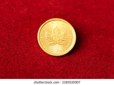 Gold Maple Leaf Coin With Red Background