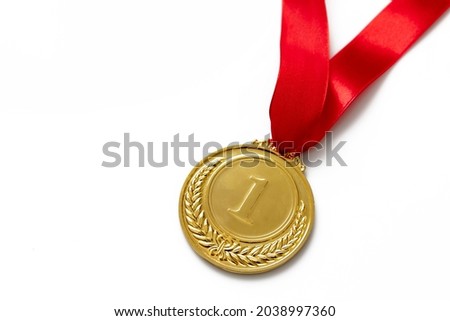 Gold medal, number one laurel wreath and red color ribbon isolated on white background, Champion first place winner athlete. Prize in sport trophy award, copy space, template.