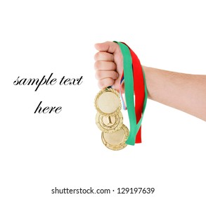 Gold Medals In Hand Isolated On White