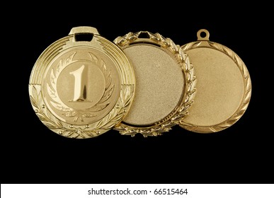 Gold Medals Isolated On Black Background