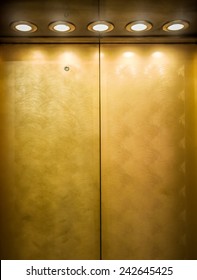 Gold Metal Door Of Elevator With Spotlights