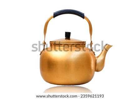 Gold metal kettle on white background. Tea pot.