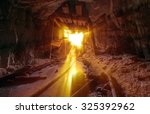 Gold Mine entrance with beams of light streaming in.