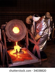 Gold Mine Worker Pours Molten Gold Into Ingot Mold