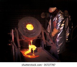 Gold Mine Worker Pours Molten Gold Into Ingot Mold