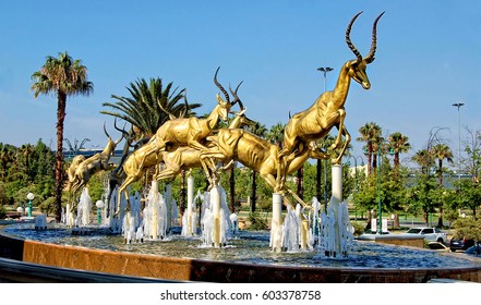 Gold. Mining Industry Of South Africa. Amazing Golden Springboks Jump In A Fountain With Blue Sky In Background. Johannesburg Gold Reef City. South Africa - December 21, 2013 