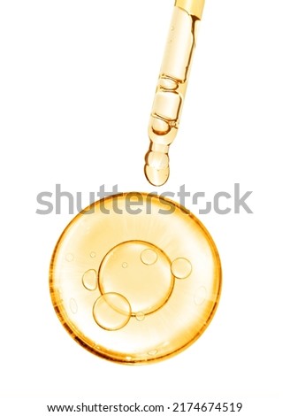 gold miracle yellow bubble vitamin oil or serum isolated on white background with laboratory glass pipette on white background. Beauty and skin care
