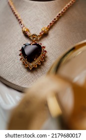 Gold Necklace And Heart-shaped Garnet Gemstones.