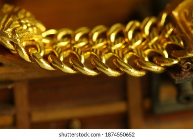 Gold Necklace And Miniature Ship Model Scene Represent Treasure And Transportation Business Concept Related Idea.