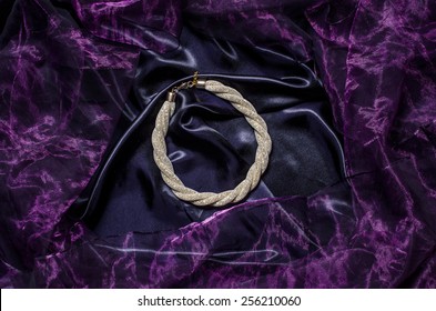 Gold Necklace On A Silk Background