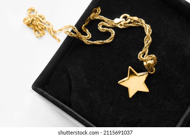 Gold Necklace With Star Shaped Pendant In Black Jewel Box