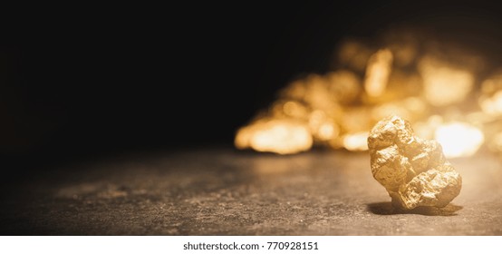 Gold Nugget In Front Of A Mound Of Gold