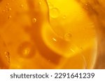 Gold Oil bubbles close up. circles of orange water macro. abstract shiny yellow background.