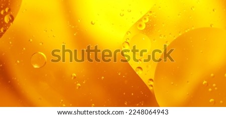 Gold Oil bubbles close up. circles of orange water macro. abstract shiny yellow background. banner