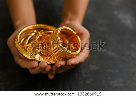 Gold ornaments women hand holding traditional jewelry in Kerala India. Kerala Indian Christian girl wearing gold jewellery old fashion. Ethnic ornaments of ancient Christian Woman.