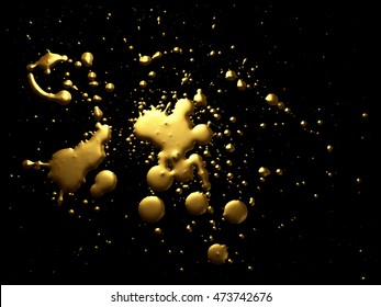 Gold paint splatter isolated on black E