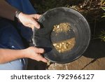 gold panning, hoping to strike it rich by finding the mother lode or at least a nugget or two
