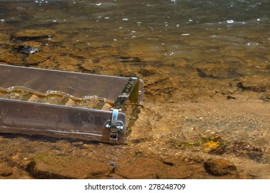 Gold Panning In A River With A Sluice Box