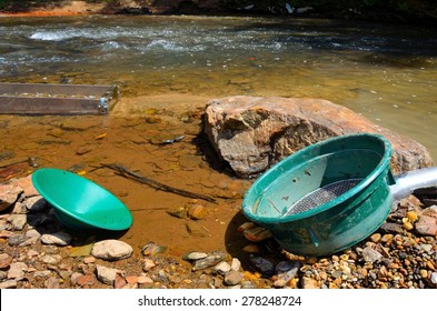 Gold Panning In A River With A Sluice Box