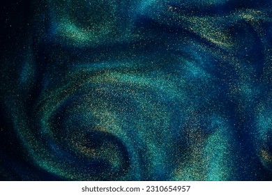 Gold Particles In Blue Fluid. Golden sparkling dust particles floating in a blue liquid with green tints, creating fantasy curved patterns and waves. Magic glittering galaxy. - Powered by Shutterstock