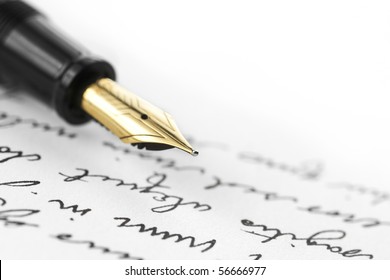 Gold Pen With Hand Written Letter. Focus On End Tip Of Fountain Pen.