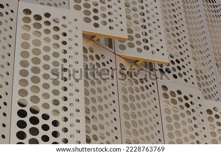 Gold perforated cladding on the outside of a building