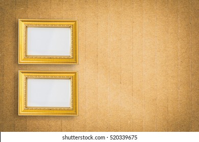 Gold photo frame on brown paper texture