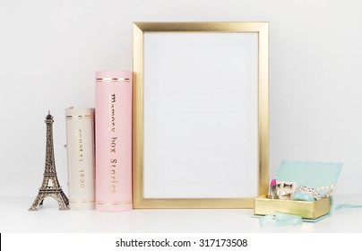 gold picture frame with decorations. Mock up for your photo or text Place your work, print art,shabby style, white background,, pastel color book, paris, lipstick, mint and gold accessories
 - Shutterstock ID 317173508