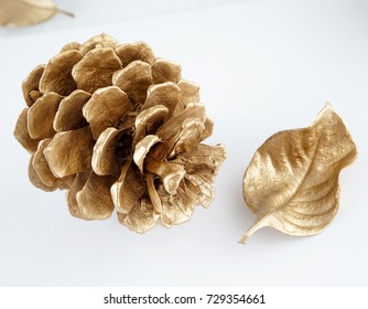 Gold Pinecone And Gold Leaf. Christmas Decoration. Isolated On White Background