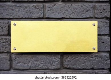 Gold Plaque On A Gray Brick Wall