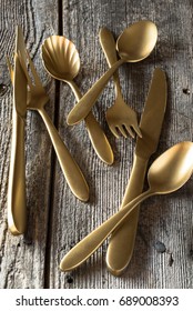 Gold Plated Flatware On Rustic Background