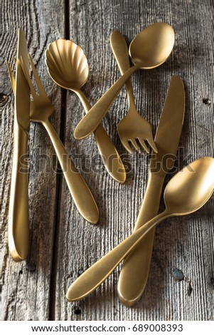 Gold Plated Flatware on Rustic Background