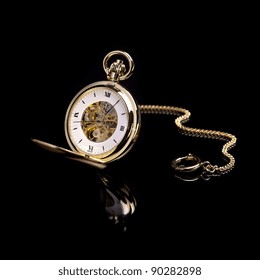 Gold Pocket Watch On A Black Background