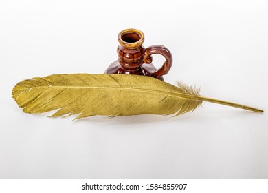 Gold Quill Pen And Antique Inkstand On A White Background