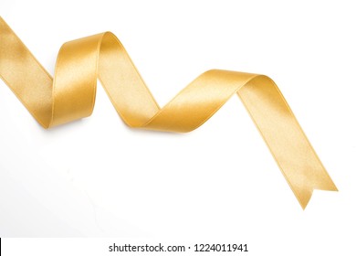 Gold Ribbon In Roll On White Background