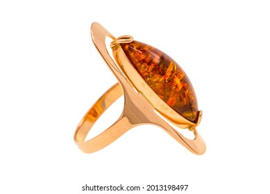 A gold ring with amber. Fashion jewelry is isolated on a white background