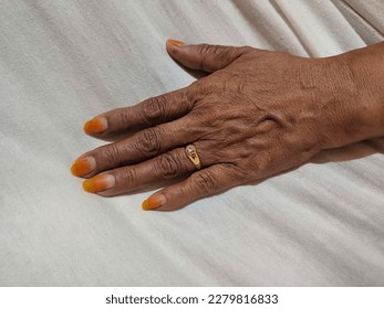 gold ring attached to a mother's ring finger - Shutterstock ID 2279816833