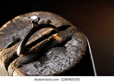 gold ring with brilliant cut diamond in goldsmith workshop - Shutterstock ID 2280405193