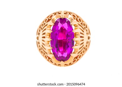A gold ring with a large pink stone. The jewelry is isolated on white