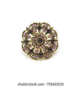 gold round brooch with purple diamonds isolated on white