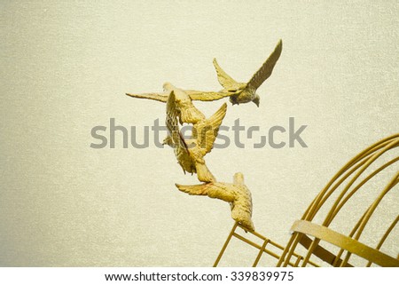 gold Sculpture of a Dove Being Set Free
