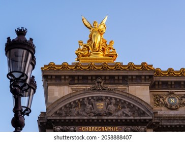 Gold Sculpture On Top Of Paris Opera, Taken On A Spring Morning With A Parisian Standard Light Pole In The Foreground, With No People.