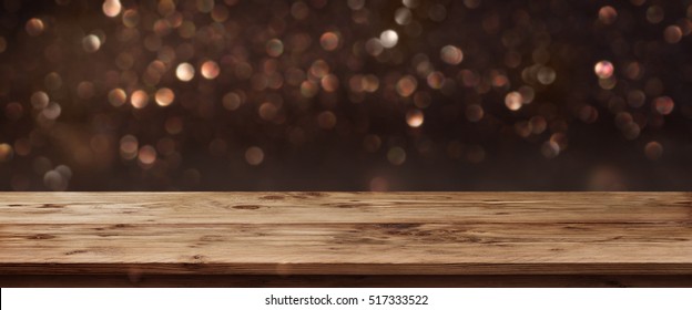 Gold shimmering panorama for public holidays in front of a wooden table and a concept