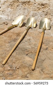 Gold Shovels Lay At A Construction Site After A Ground Breaking Ceremony.