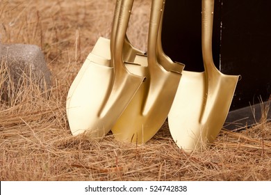 Gold Shovels Stacked Waiting For Ground Breaking Ceremony. 