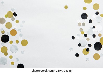 Gold, Silver, Black And White Foil Confetti Sparse On White Background. Simple Holiday Concept. Copy Space For Text. Top View, Flat Lay